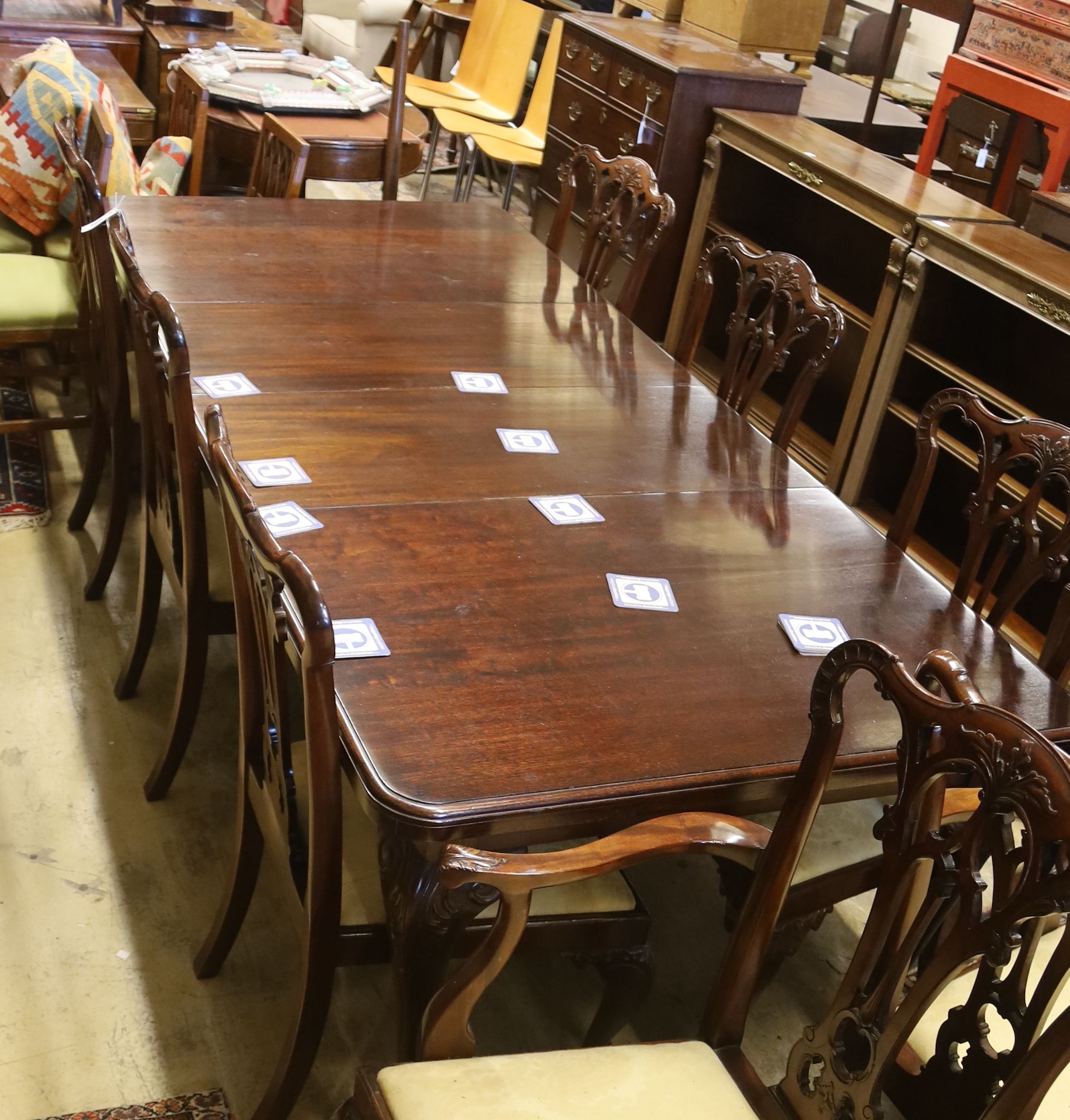 A set of eight George III style mahogany dining chairs with ball and claw feet together with a similar mahogany extending dining table, length 240cm extended (two spare leaves), width 106cm, height 74cm